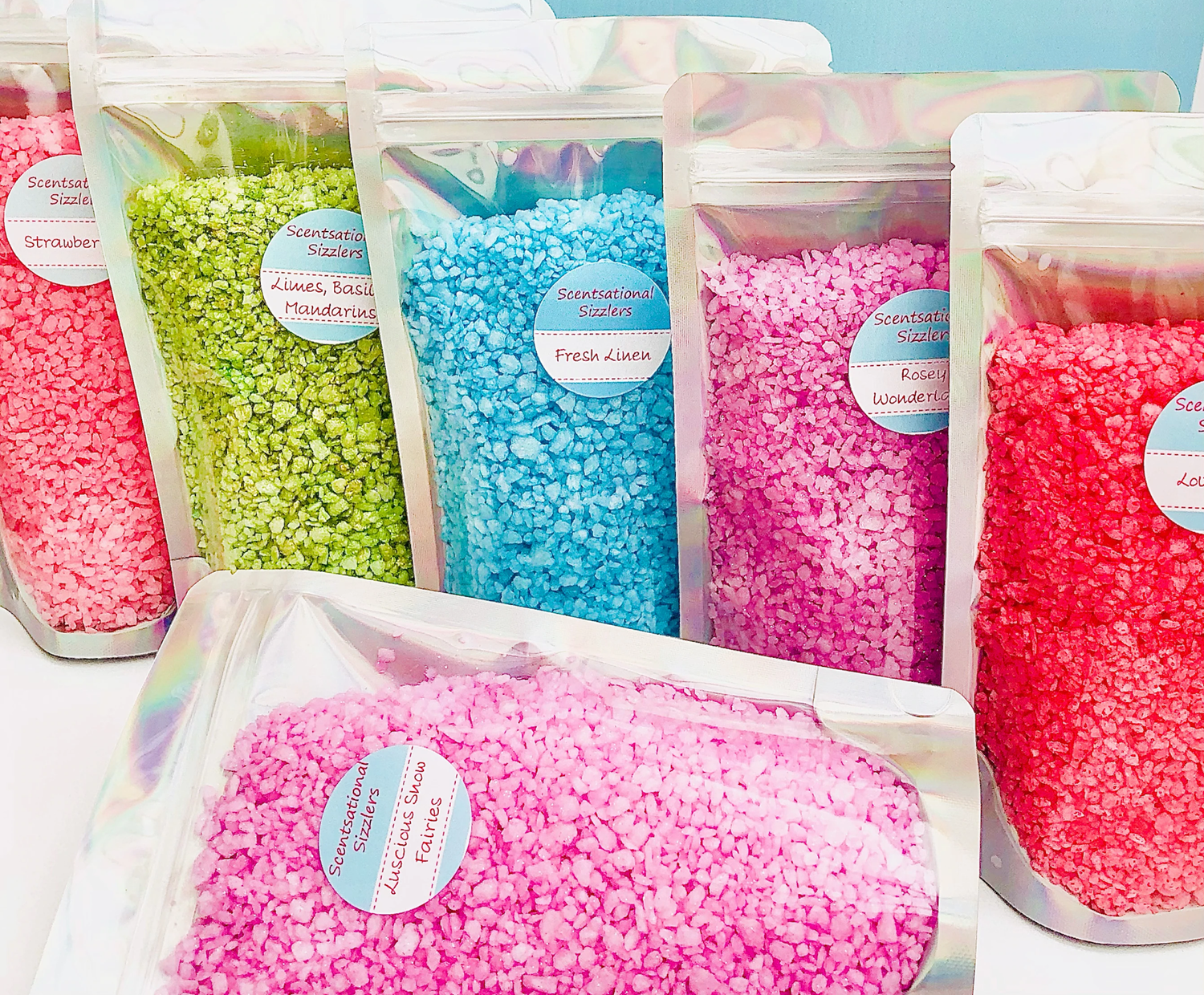 Six pouches of sizzler granules in bright colours.